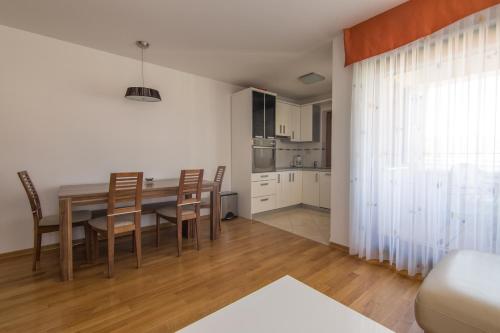 a dining room and kitchen with a table and chairs at Villa Novak in Okrug Donji