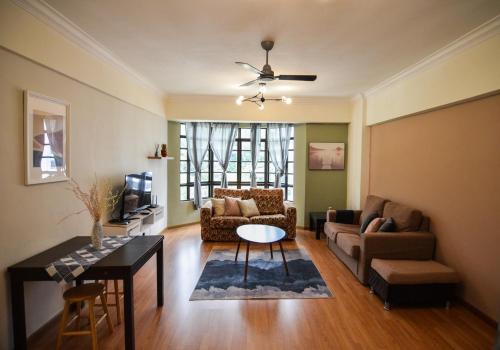 a living room with a couch and a table at 7pax-Genting Premium Outlet LARGEST Family Retro English Cottage - F-Parking, Self C-In in Genting Highlands