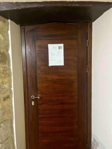 a wooden door in a room with a paper on it at Appartamento in casale rustico - La Masseria in Busso