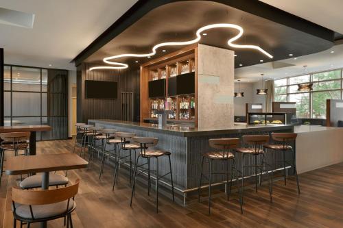 a bar in a restaurant with stools at Residence Inn by Marriott Calgary Airport in Calgary