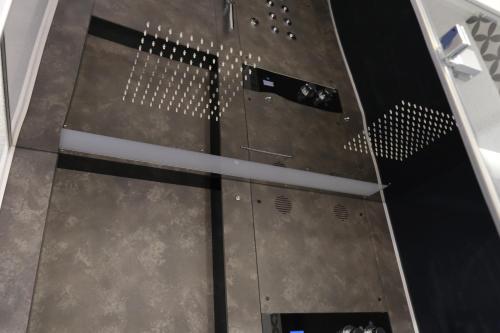 a glass door in a room with a metal floor at TANIT ROOMS & SPA in Villasimius