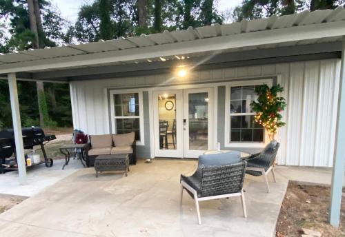 a covered patio with chairs and a table at Game Junction in Montgomery