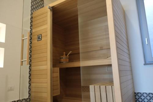 a walk in closet in a house with a glass door at TANIT ROOMS & SPA in Villasimius