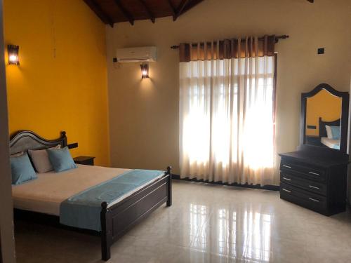 Voodi või voodid majutusasutuse Sun Star Villa Negombo toas