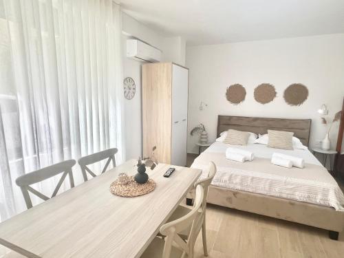 a bedroom with a bed and a table and chairs at Art Studio Apartments Durrës in Durrës