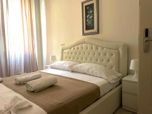 a bed with two pillows on it in a bedroom at Hotel Fiammetta in Rimini