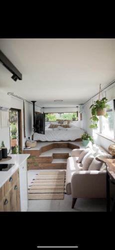 a living room with a large bed and a couch at Leobus-לאו באס in Menaẖemya
