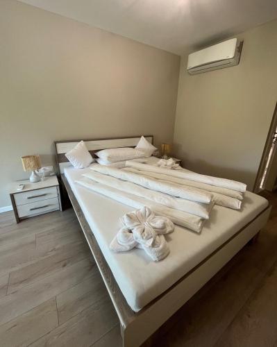 two beds in a room with towels on them at Muki House in Hunedoara