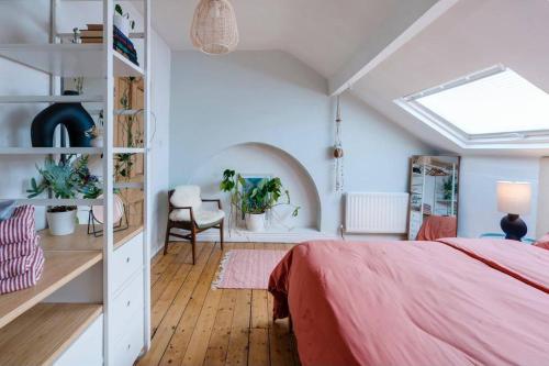 a bedroom with a pink bed and a desk at Adelaide House in Ulverston