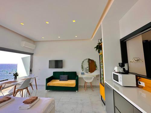a living room with a green couch and a table at Sea Horizon Vsl Suites & Apartments in Sarandë