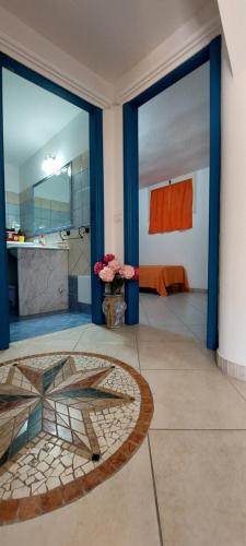 a large room with a bathroom with blue doors at Casa Vacanze Laura in Tortolì