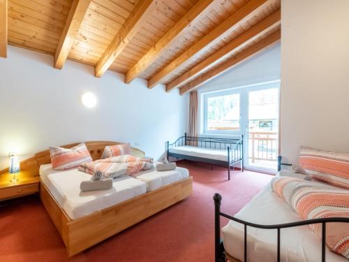 a bedroom with a bed and a couch in a room at Haus Anna in Längenfeld