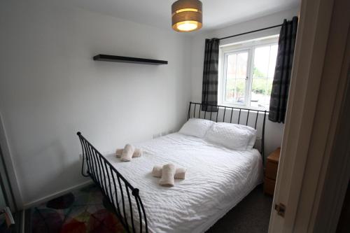 a bedroom with a bed with two towels on it at Lymm House in Lymm