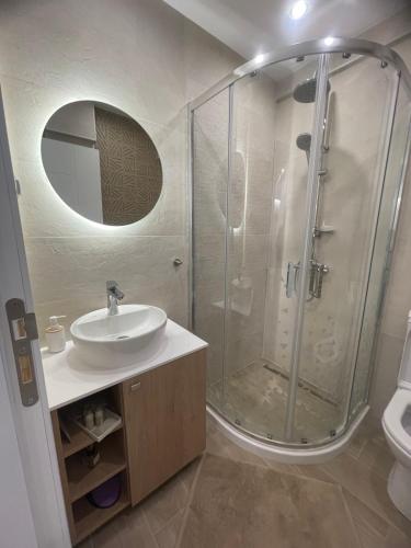 a bathroom with a shower and a sink at Sea Esta Apartment in Nea Peramos