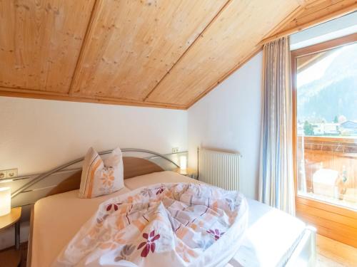 a bedroom with a bed and a window at Haus Anna in Längenfeld