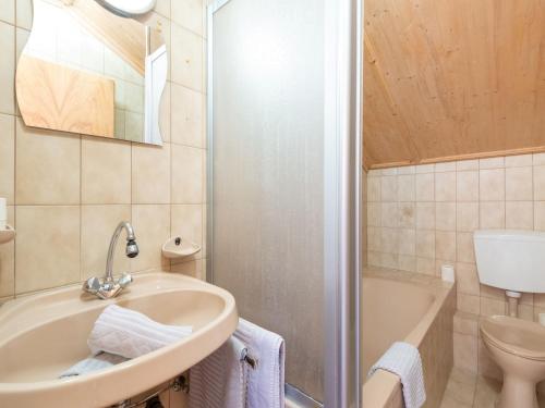a bathroom with a sink and a toilet and a tub at Haus Anna in Längenfeld