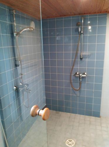 a bathroom with a shower with blue tiles at Vintage 50's in Lahti