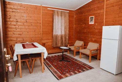 a kitchen with a table and chairs and a refrigerator at Village of Peace - House 26 in Shkodër