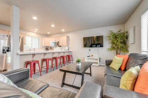 a living room with a couch and a table at Family-Friendly St George Condo with Community Pools in St. George