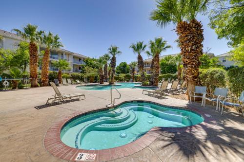 a swimming pool in a courtyard with palm trees at Family-Friendly St George Condo with Community Pools in St. George