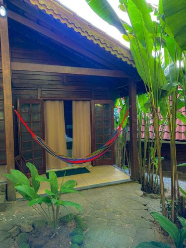 a red rope hanging from the front of a house at Pousada Mata Nativa in Abraão