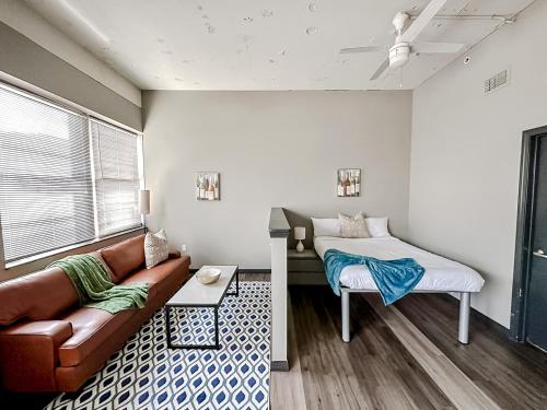 een woonkamer met een bank en een bed bij Sleepover Luxe Downtown Springfield Apartments in Springfield