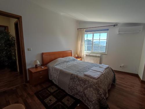 a bedroom with a bed and a window at Encosta do Pinhão in Casal de Loivos