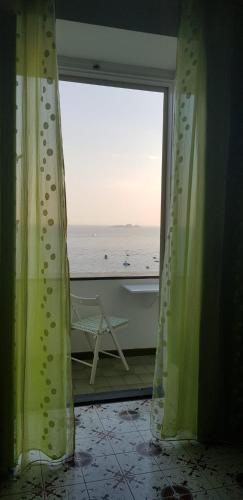 a room with a window with a view of the ocean at Relais Zio Vincenzo Casa Positano in Positano
