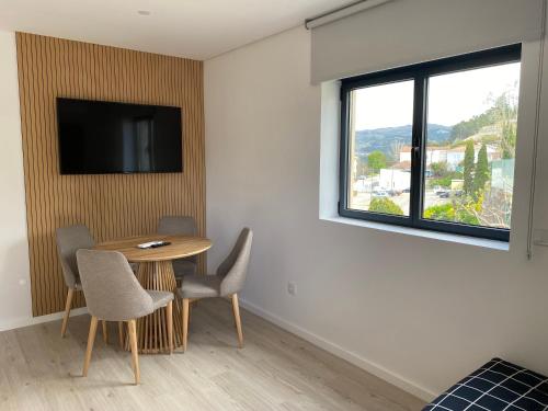 a room with a table and chairs and a window at Casa da Zéfinha - Villa, em Cinfães, no Douro in Cinfães