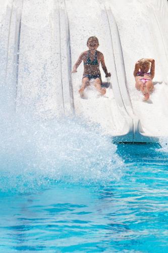 two people on a water slide in the water at Cyprotel Faliraki in Faliraki