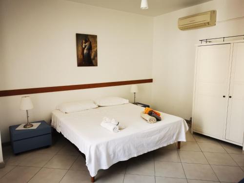 a bedroom with a bed with two towels on it at Dimora alla Villa in Ostuni