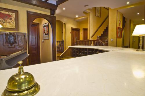 a room with a white counter top and a staircase at Apartamentos Capriccio in Santillana del Mar