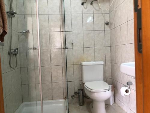 a bathroom with a shower and a toilet and a sink at Villa Cabral - Sea view, WIFI & swimming pool in Sal Rei