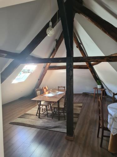 een eetkamer met een tafel en stoelen op een zolder bij Glaciar Guest House in Manteigas