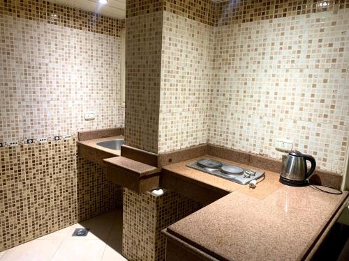 a small kitchen with a tea kettle on a counter at Airport hostel room for transit in Cairo