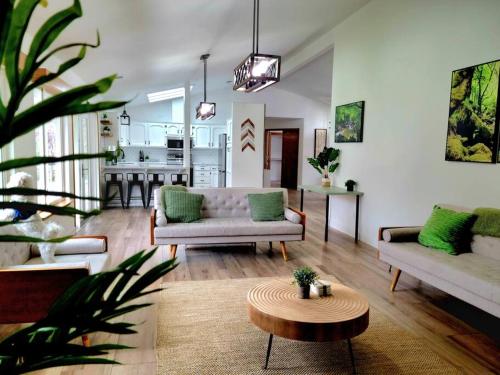 a living room with two couches and a table at Oasis Riverfront House -10 min to Sequoia in Three Rivers