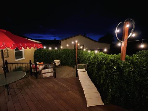 a patio at night with lights on a hedge at Spacious Renovated Petaluma Home- Pool Table, Fire Pit, Parking in Petaluma