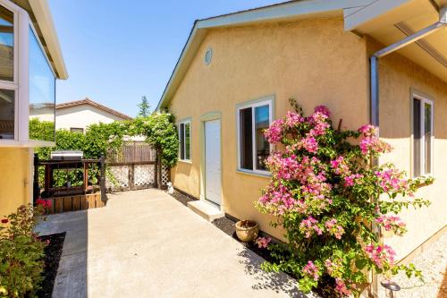a house with pink flowers on the side of it at Spacious Renovated Petaluma Home- Pool Table, Fire Pit, Parking in Petaluma