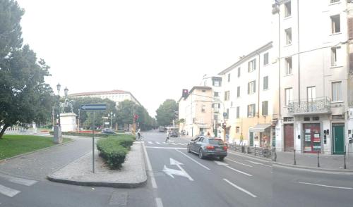 a car driving down a city street with buildings at Appartamento Tiffany in Brescia