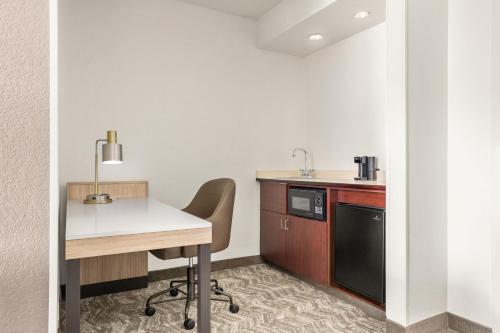 a kitchen with a table and chairs in a room at SpringHill Suites Boston Andover in Andover