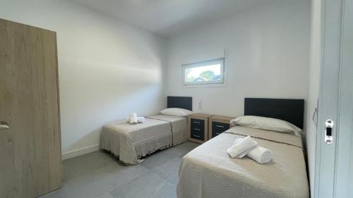 a bedroom with two beds and a window at Villa Piluca Hotel Rural in Pelayos de la Presa