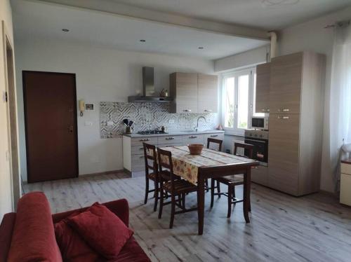 a kitchen with a table and chairs in a room at Angela in Garessio