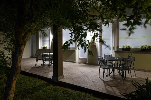 a group of tables and chairs in a building at Hotel Internazionale in Domodossola