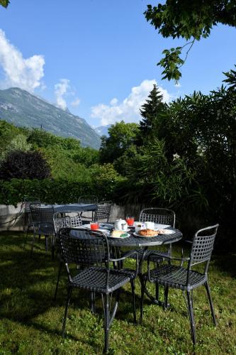 a table and chairs with food on it in the grass at Hotel Internazionale in Domodossola