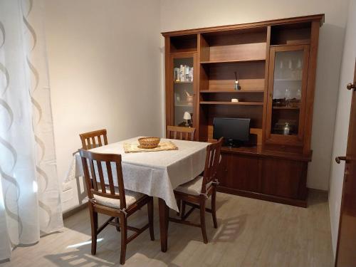 een eetkamer met een tafel en stoelen en een televisie bij Casa Cozy - Comodo Appartamento in Asti Centro in Asti