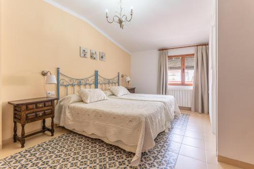 a bedroom with a bed and a table and a window at Casas de Poniente in Cehegín
