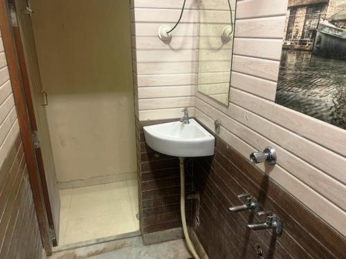 ein Bad mit einem Waschbecken und einem Spiegel in der Unterkunft 5 Mint Walking from Dargah Hotel Dabi Palace in Ajmer