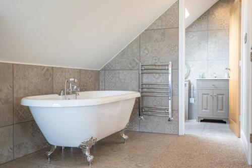 - Baño con bañera blanca y escalera en Valley View Luxury Lodges Gamekeepers 4 Bedroomed, en Preston