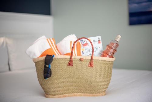 a basket filled with towels and a book on a table at Cape Colony Inn in Provincetown
