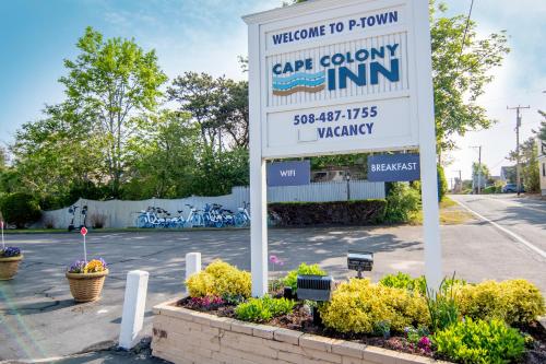 a sign for a cape colony inn in a parking lot at Cape Colony Inn in Provincetown